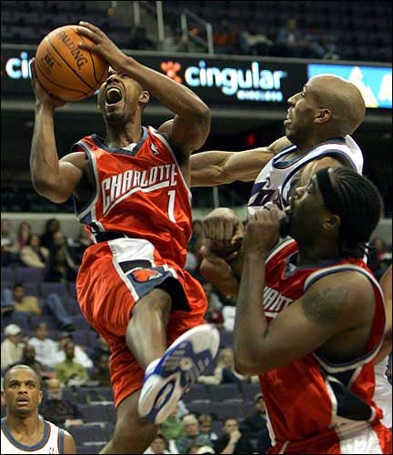 NBA Expansion Team Charlotte Bobcats guard Jason Hart, left, goes up for a shot over teammate Melvil Ely, lower right, and Washington Wizards forward Michael Ruffin. Hart, shown Sunday in Washington, and the Bobcats will face a tough road in their inaugural season.